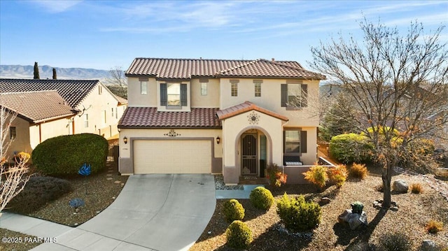 mediterranean / spanish home featuring a garage and a mountain view