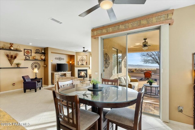 tiled dining room with ceiling fan