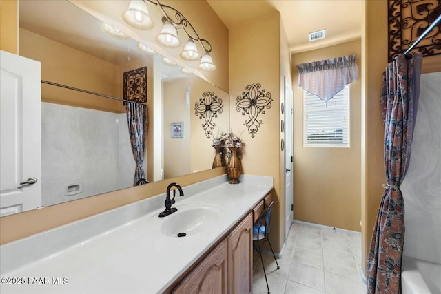 bathroom with vanity, tile patterned floors, and shower / bath combo with shower curtain