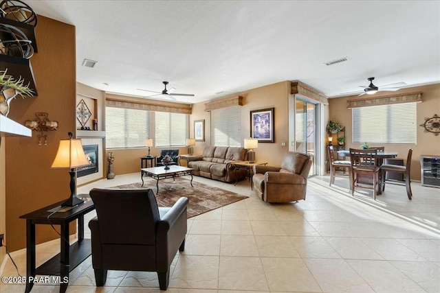 living room with light tile patterned flooring and ceiling fan