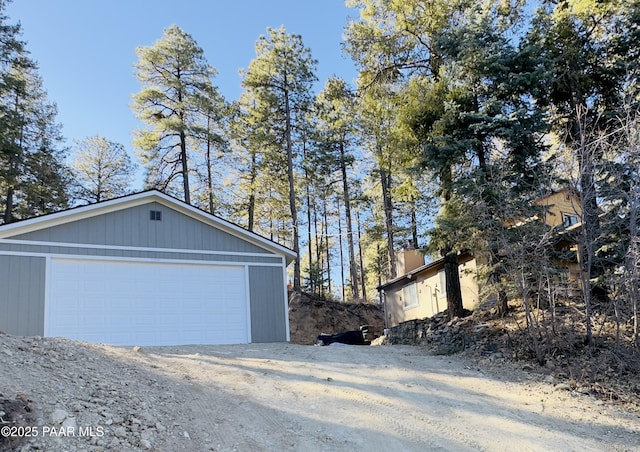 view of property exterior featuring a garage and an outbuilding