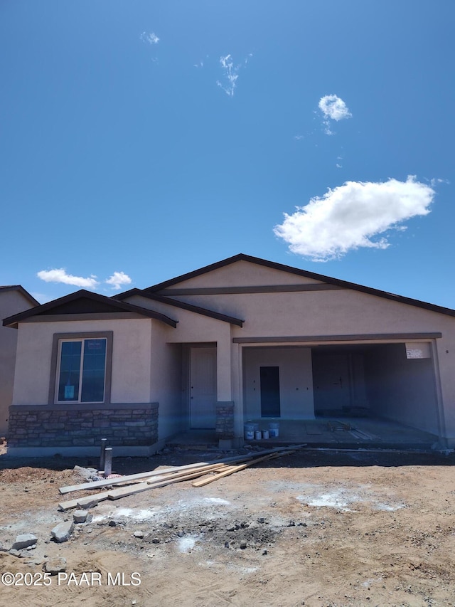 view of front of property with stucco siding and stone siding