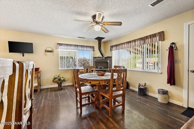 1819 Mountain View Ln, Prescott, AZ 86301 - dining space featuring a wood stove, wood finished floors, ceiling fan, and a textured ceiling