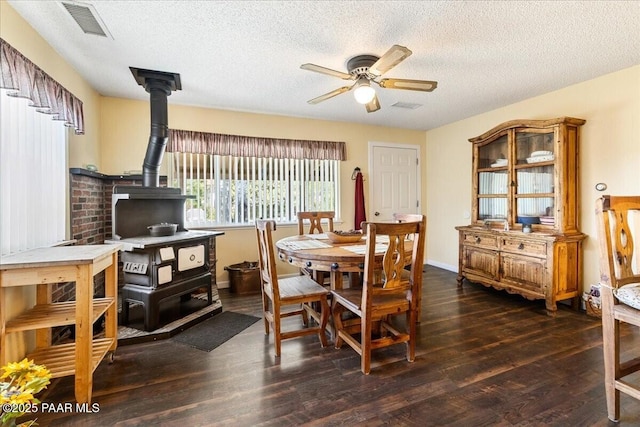 1819 Mountain View Ln, Prescott, AZ 86301 - dining area featuring a wood stove, a ceiling fan, wood finished floors, and a textured ceiling