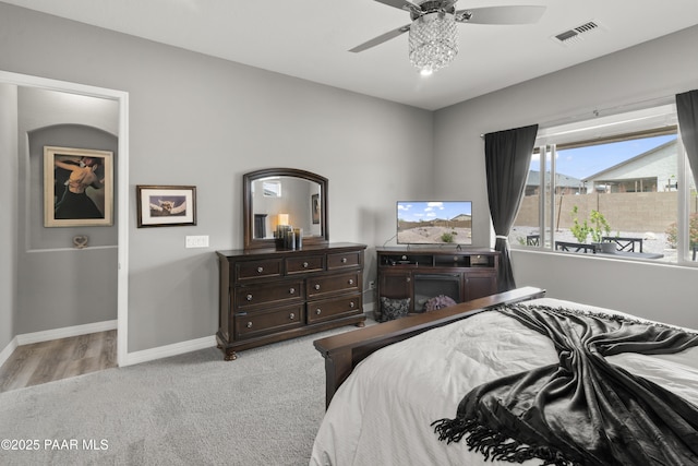 carpeted bedroom featuring visible vents, ceiling fan, and baseboards