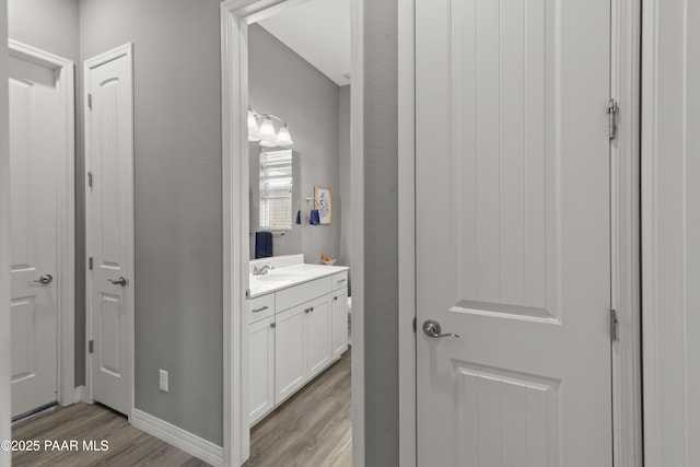 bathroom with wood finished floors and vanity