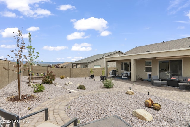 view of yard with a patio area, an outdoor hangout area, and a fenced backyard