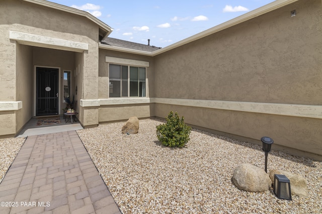 doorway to property with stucco siding