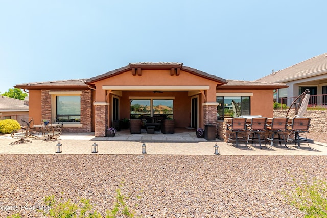 1646 Constable St, Prescott, AZ 86301 - back of house featuring stucco siding, a patio area, stone siding, and a tiled roof