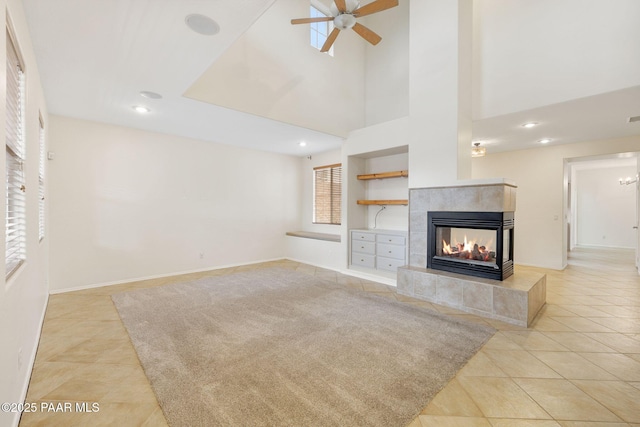 7070 E Lantern Ln, Prescott Valley, AZ 86314 - unfurnished living room with light tile patterned floors, a fireplace, a ceiling fan, and recessed lighting