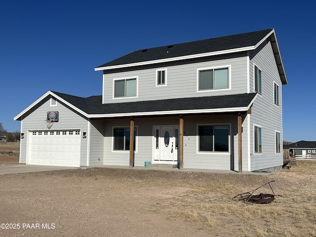 view of front of house featuring a garage and dirt driveway