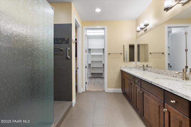 bathroom featuring vanity and tiled shower