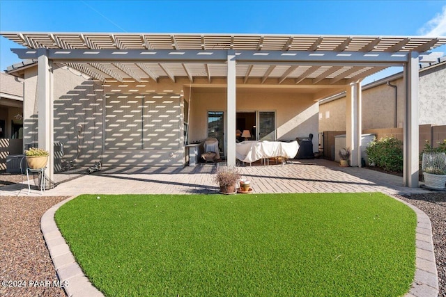 back of property with a yard, a pergola, and a patio