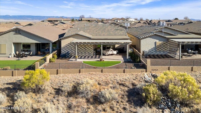 back of house with a mountain view and a patio area