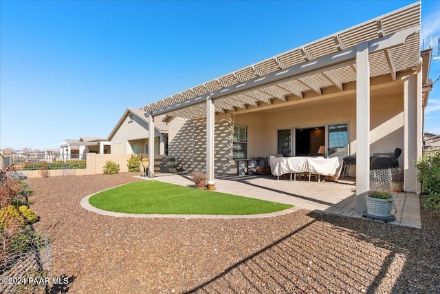 back of property featuring a pergola and a patio