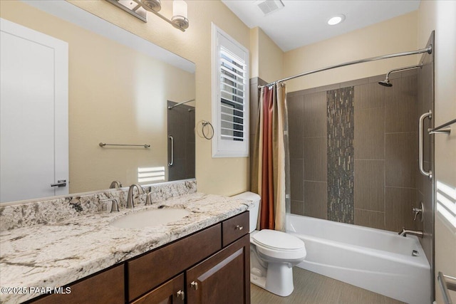 full bathroom with vanity, shower / bath combination with curtain, and toilet