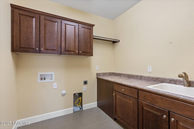 laundry area with gas dryer hookup, sink, cabinets, hookup for a washing machine, and electric dryer hookup