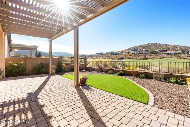 view of patio with a mountain view and a pergola