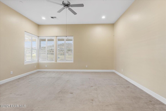 carpeted spare room with ceiling fan