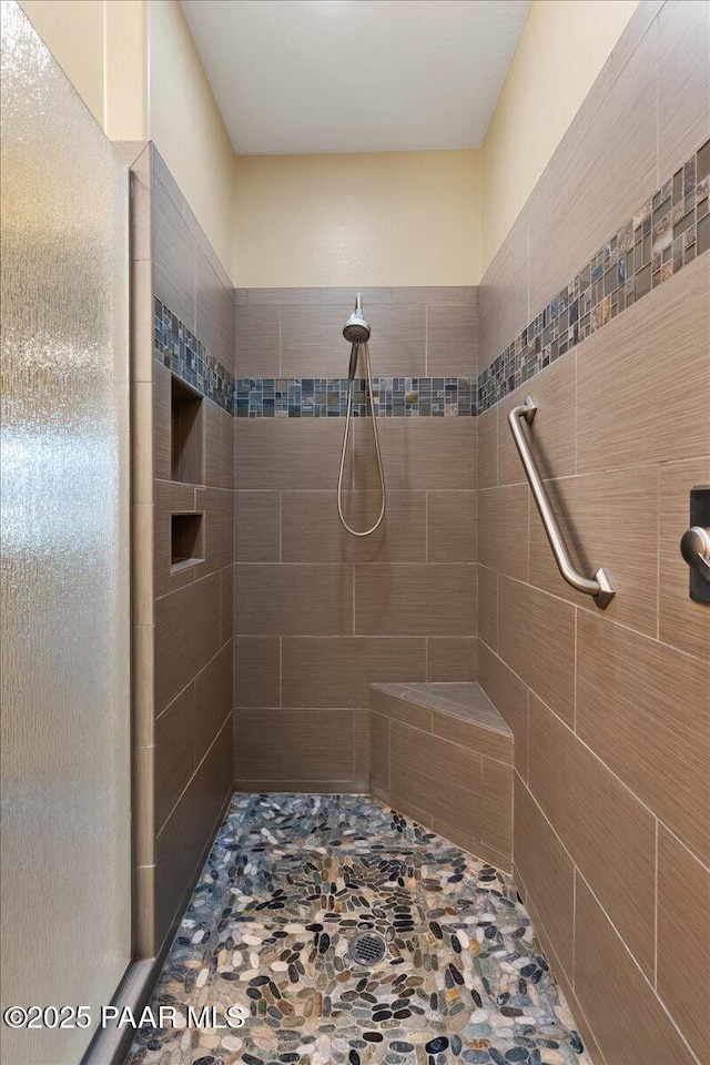 bathroom with a tile shower