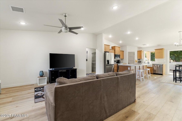 4956 E Ramada Dr, Prescott, AZ 86301 - living area featuring vaulted ceiling, light wood finished floors, ceiling fan, a chandelier, and recessed lighting