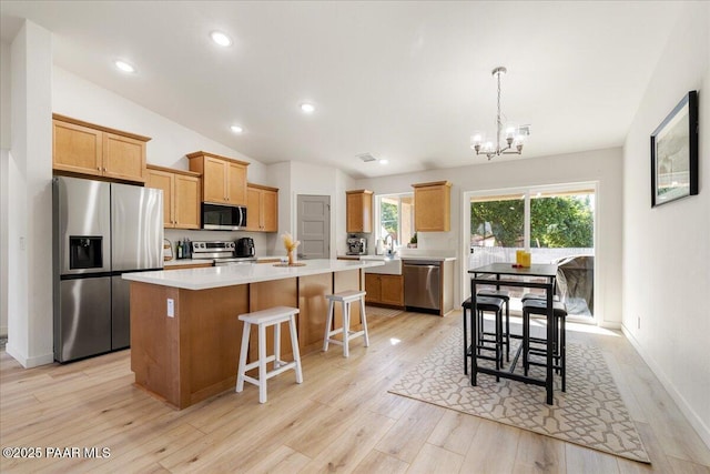 4956 E Ramada Dr, Prescott, AZ 86301 - kitchen with appliances with stainless steel finishes, a chandelier, a center island, light countertops, and light wood-style floors