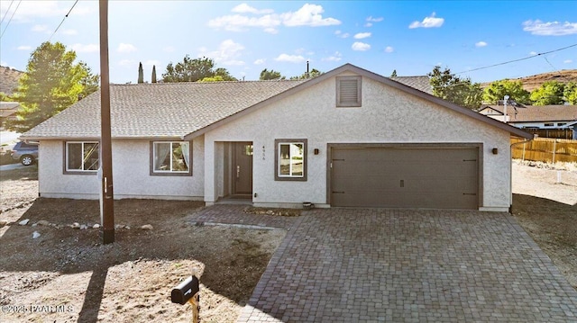 4956 E Ramada Dr, Prescott, AZ 86301 - view of front of home featuring a garage, stucco siding, and decorative driveway