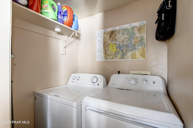 clothes washing area with washing machine and clothes dryer