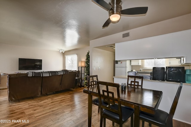 dining room with ceiling fan and wood-type flooring