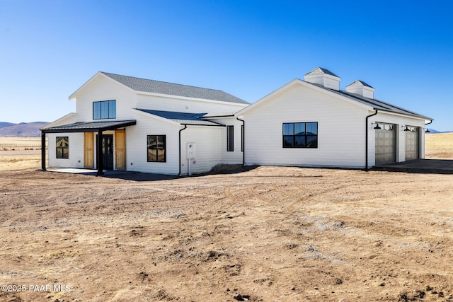 rear view of house with a garage