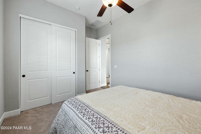 carpeted bedroom featuring a closet and ceiling fan