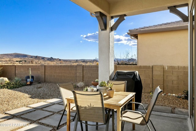 view of patio with a mountain view and grilling area