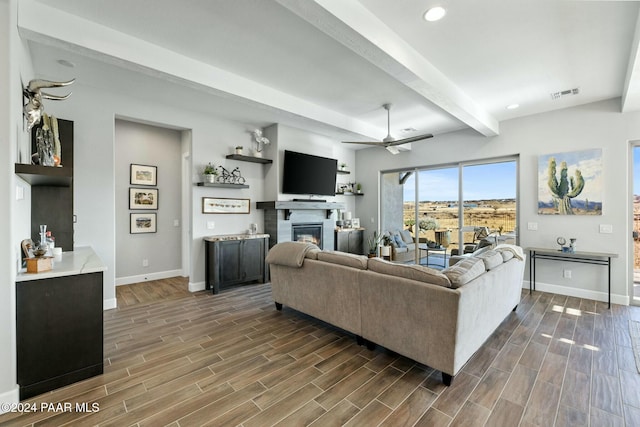 living room featuring beam ceiling, ceiling fan, and dark hardwood / wood-style flooring