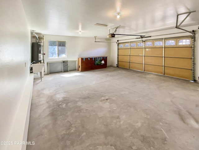 garage with gas water heater and a garage door opener