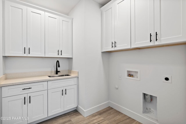 clothes washing area with cabinets, hookup for a gas dryer, sink, washer hookup, and hookup for an electric dryer