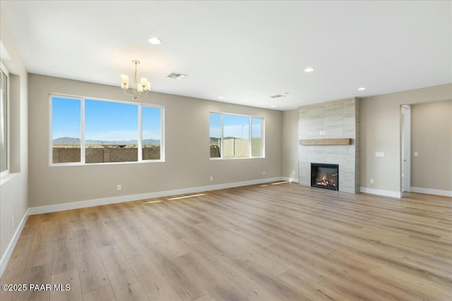 unfurnished room with baseboards, wood finished floors, and a chandelier