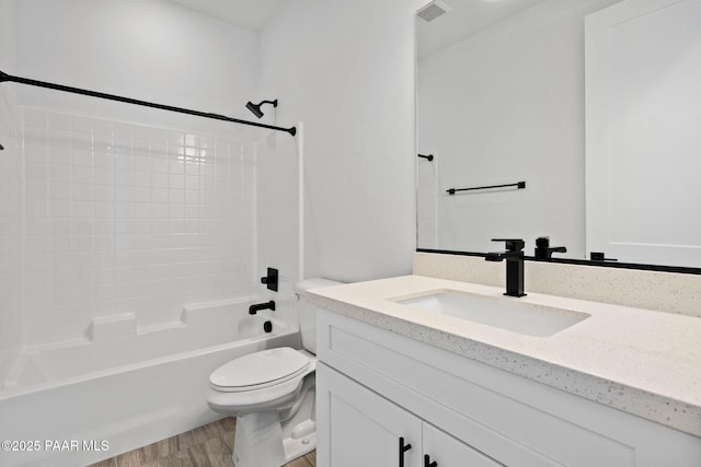 full bathroom featuring hardwood / wood-style flooring, vanity, toilet, and shower / washtub combination