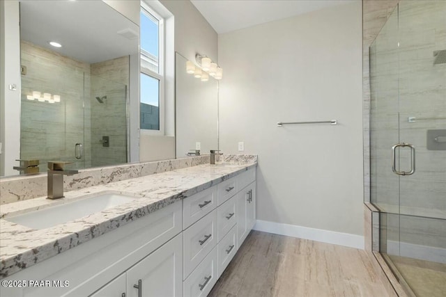 full bathroom with a stall shower, double vanity, visible vents, and a sink
