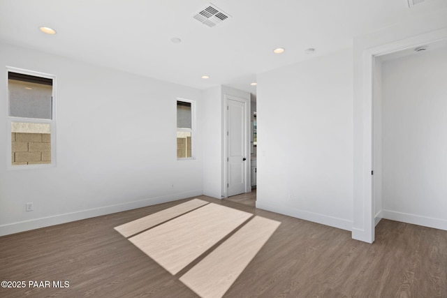 empty room featuring dark hardwood / wood-style flooring