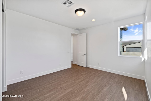 spare room featuring dark hardwood / wood-style floors