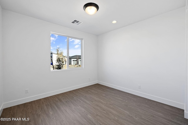 unfurnished room featuring dark wood-type flooring