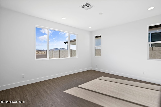 spare room featuring dark hardwood / wood-style flooring