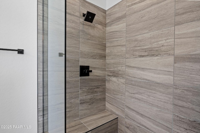 bathroom with tiled shower