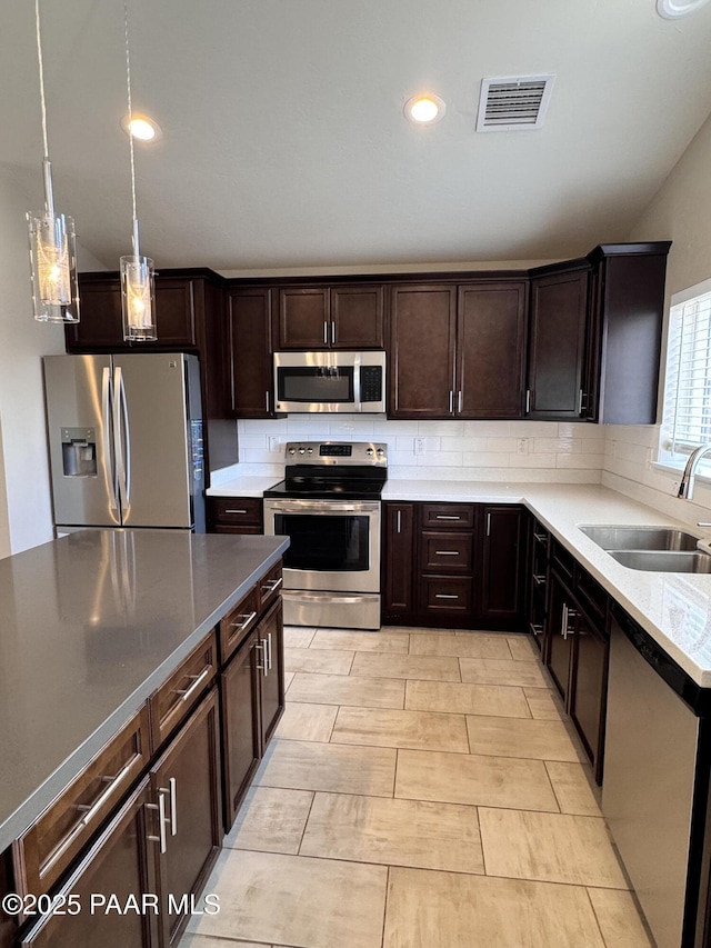 7728 E Vista Cir, Prescott Valley, AZ 86314 - kitchen with appliances with stainless steel finishes, a sink, dark brown cabinets, backsplash, and recessed lighting