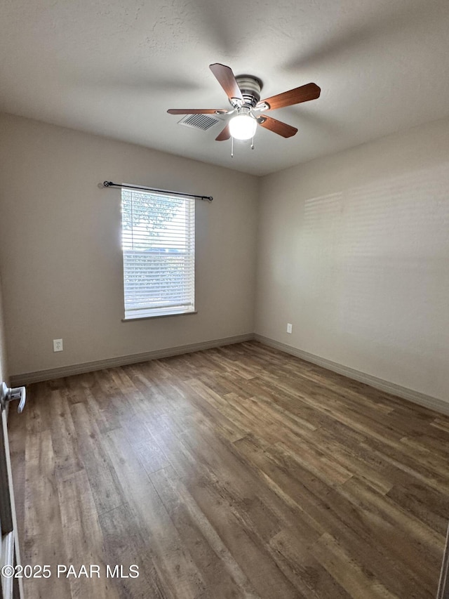 7728 E Vista Cir, Prescott Valley, AZ 86314 - unfurnished room with wood finished floors, ceiling fan, and baseboards
