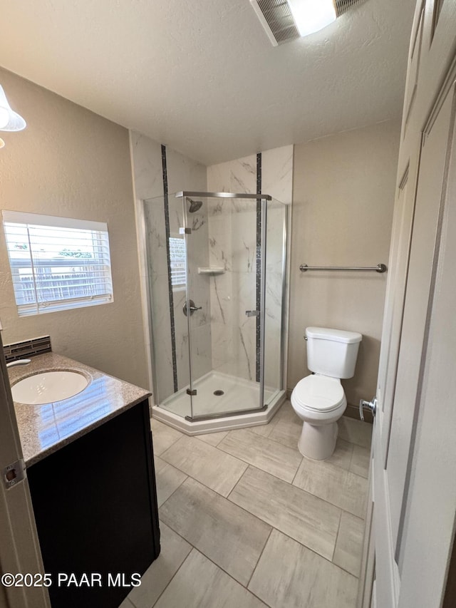 7728 E Vista Cir, Prescott Valley, AZ 86314 - full bath with toilet, vanity, a marble finish shower, a textured ceiling, and a textured wall