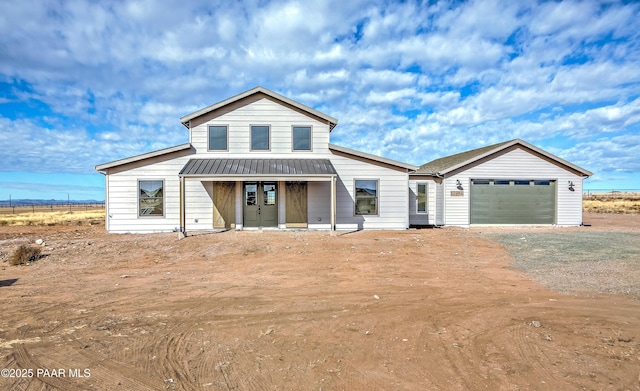 view of front facade featuring covered porch and a garage