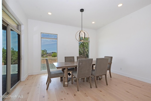 dining space with light wood finished floors, baseboards, a chandelier, and recessed lighting