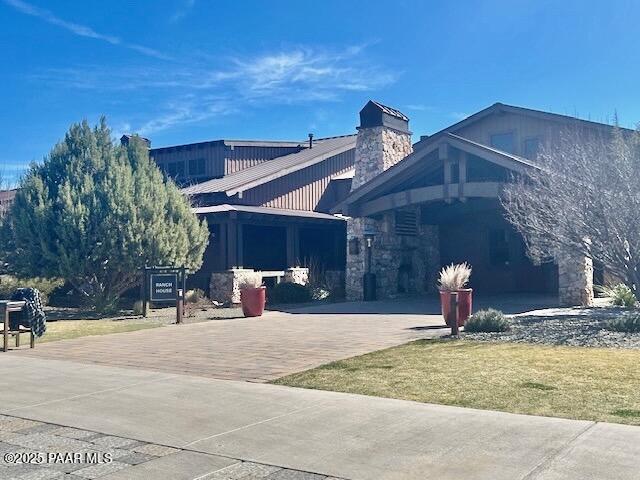 view of home's exterior featuring decorative driveway and a chimney