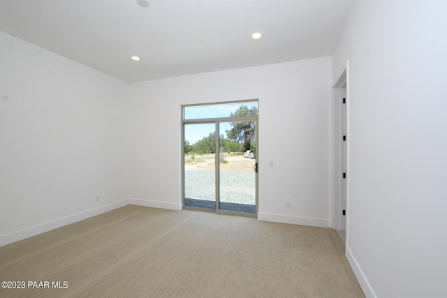 spare room featuring baseboards and recessed lighting